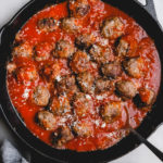 Italian meatballs in a cast iron skillet with sauce