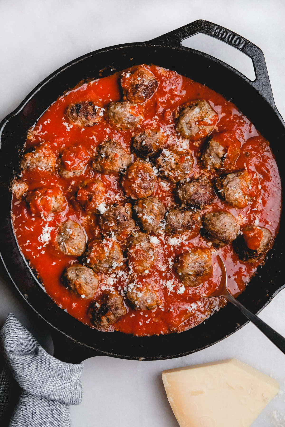 Italian meatballs in a cast iron skillet with sauce