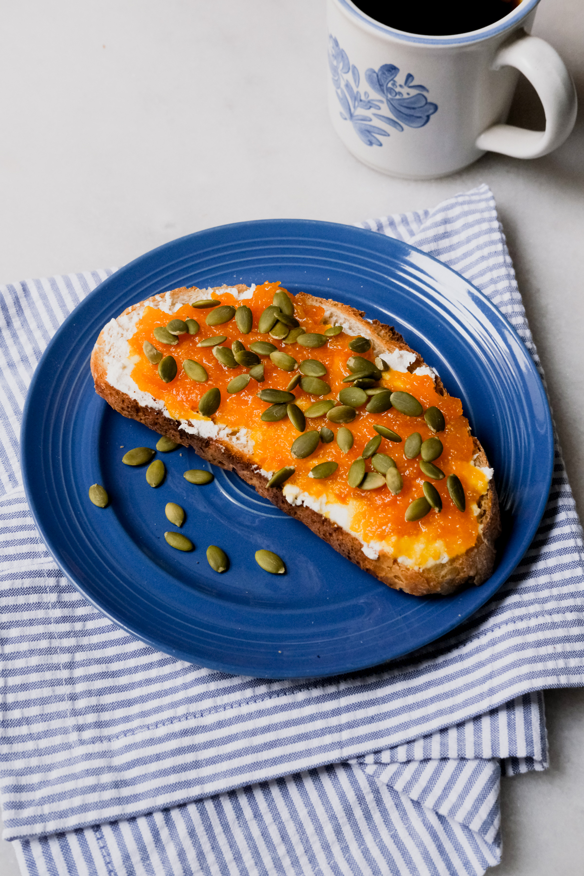 tangerine ricotta toast on a blue plate