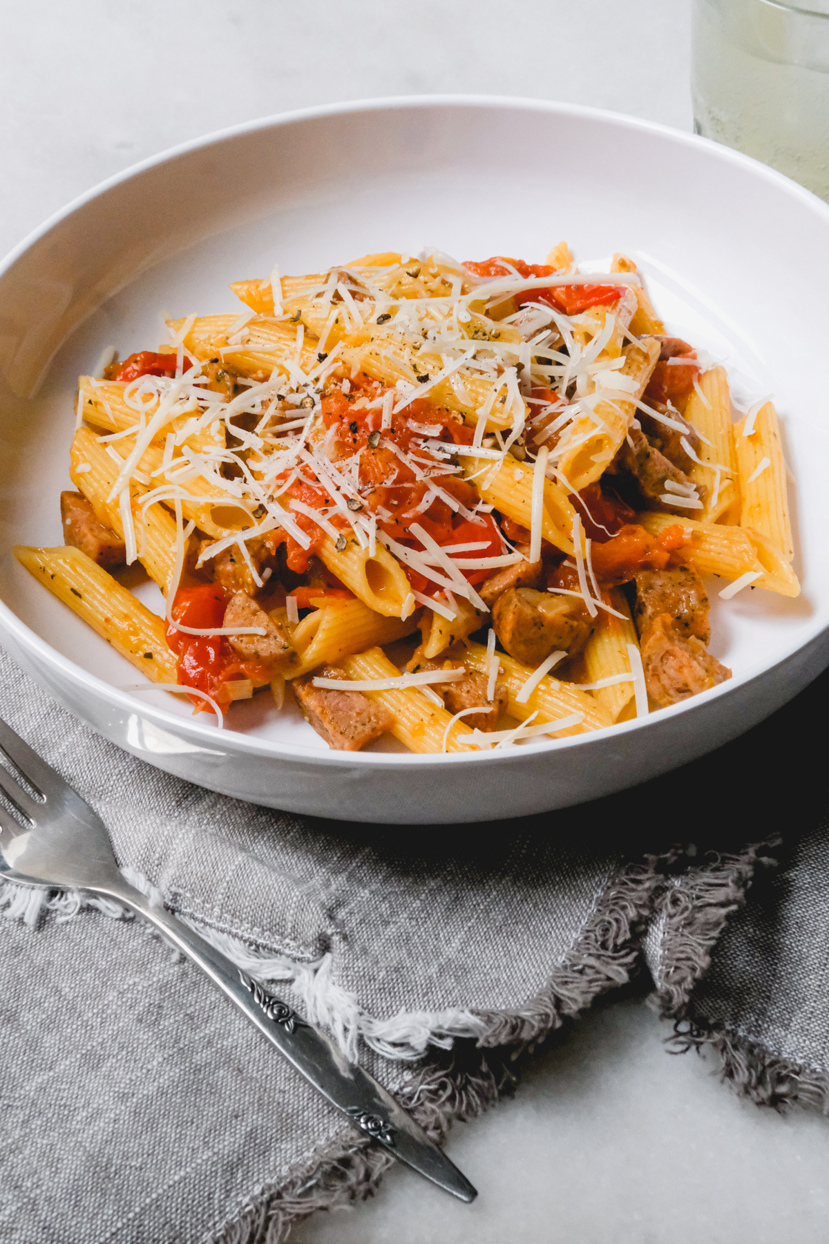 burst cherry tomato pasta with fresh cracked pepper and parmesan in a dish ready to eat