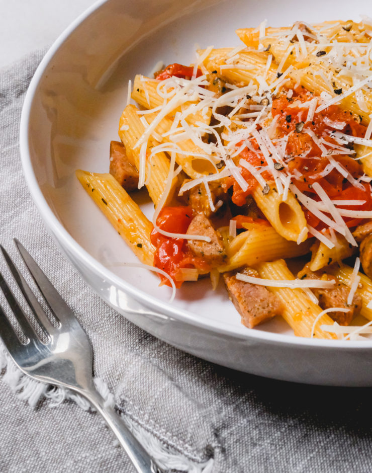 burst cherry tomato pasta with grated parmesan in a dish